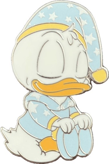 An enamel pin of a sleepy baby Donald Duck in star pajamas and a nightcap