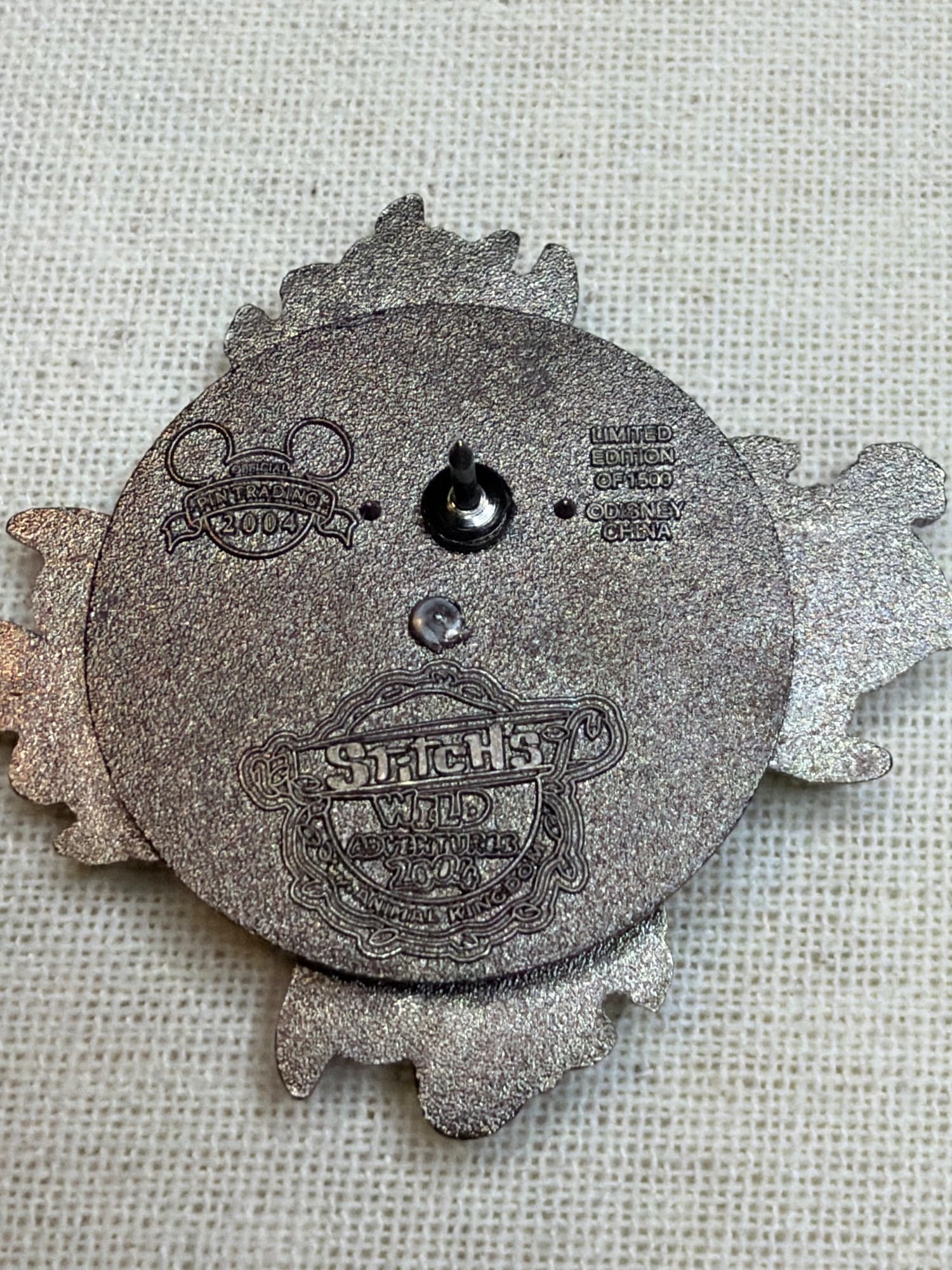 Stitch’s Wild Adventures Triceratop Spin Pin, the back