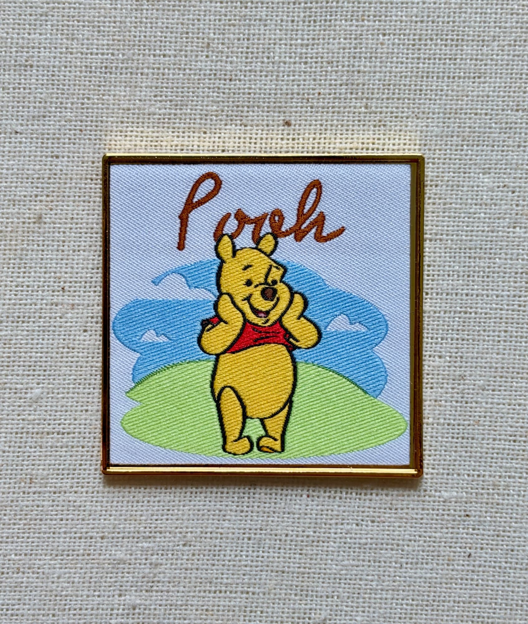 Boxlunch Pooh Embroidered Portrait Pin, the front